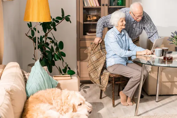 Elderly couple happy at home with their dog